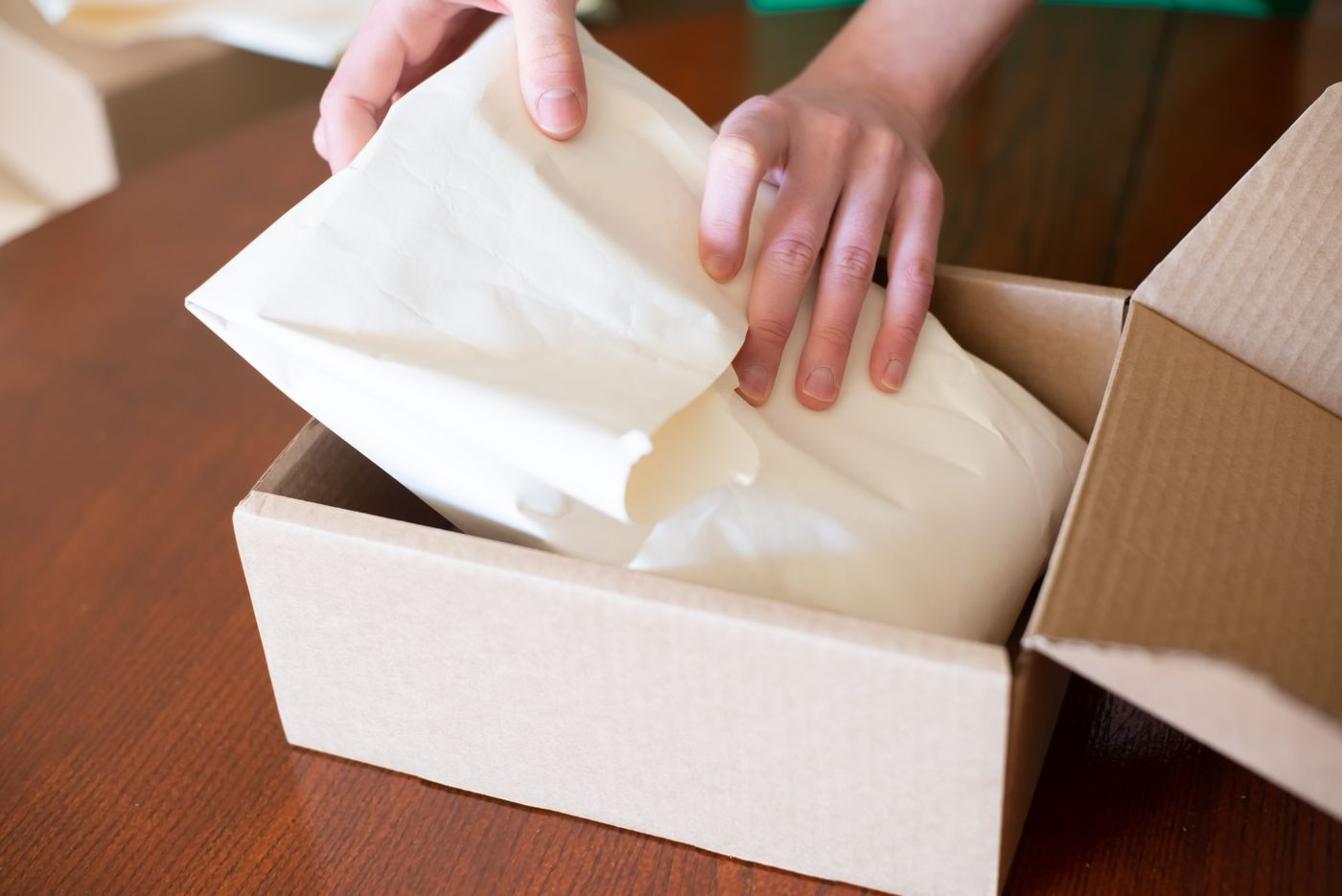 A seller packing a customer order for delivery
